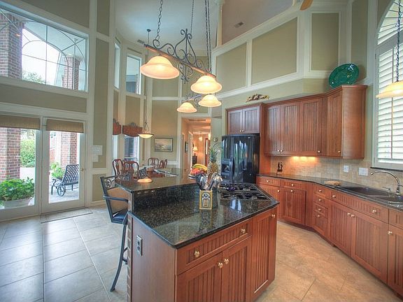 This light filled kitchen has plenty of cabinetry, breakfast bar/island and gl