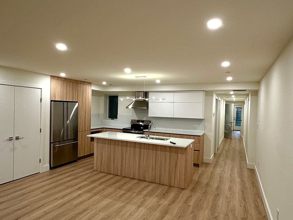 View from front door - livinghh/dining area and kitchen. Coat closet and storage with elfa hardware to the left.