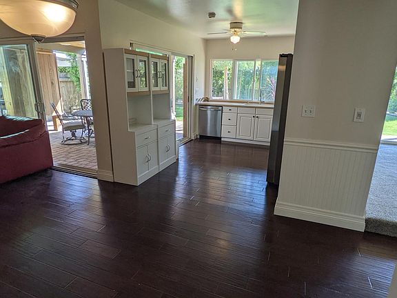 A photo from the dining room showing the kitchen and family room. Note the two large sliders for access to the patio home theater