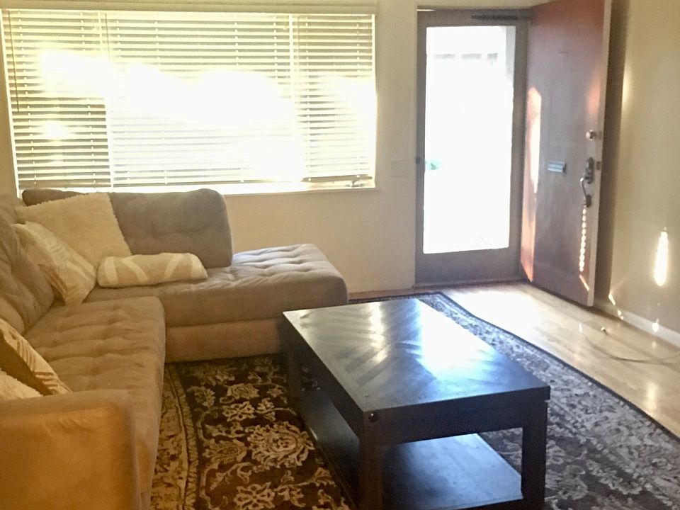 Living Room w Front Door Angle (Couch, Rug and Table to show space, not included in rental)