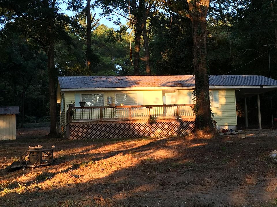 Front deck and a shed behind the house.
