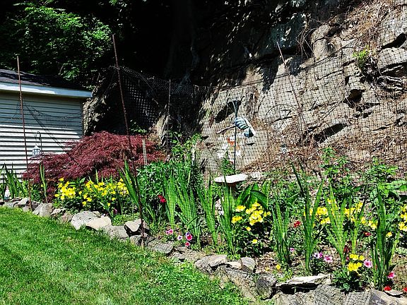 Level yard, shed, flower garden