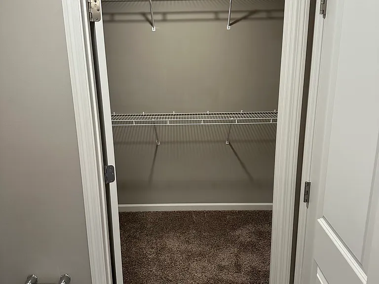 Walk-in closet for primary bedroom.