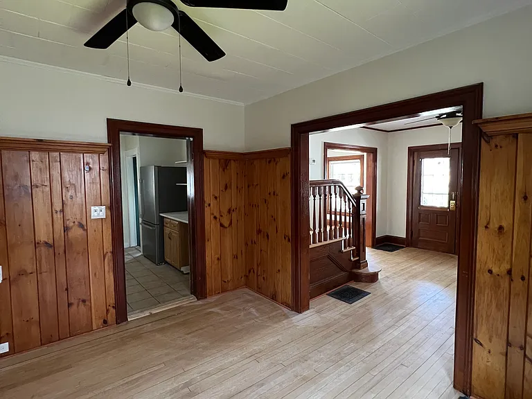 Dining room looking into kitchen and foyer