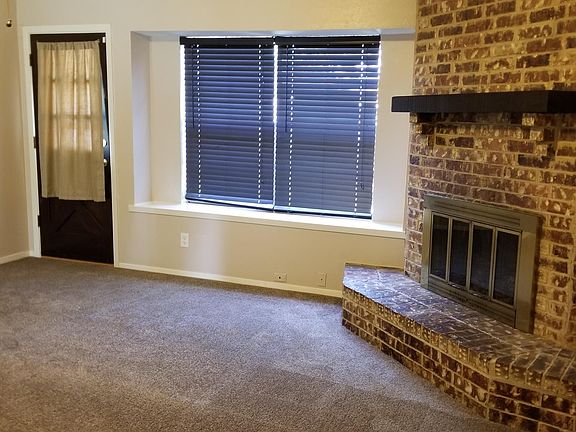 Living area. Carpet , ceiling fan and fire place.