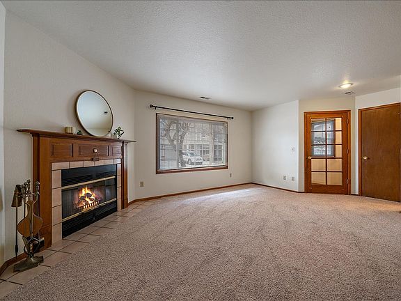 View of the enclosed entryway, spacious living room, and coat closet.