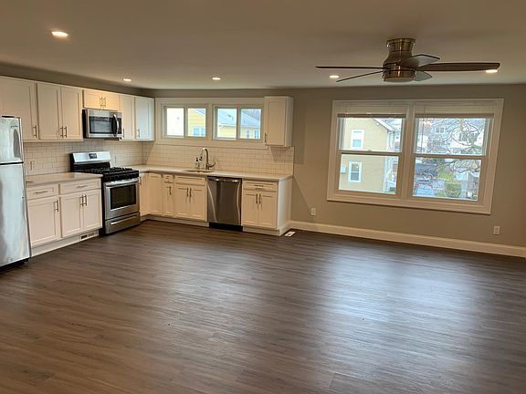 Large, open concept kitchen with stainless steel appliances, ample quality cabinetry, recessed lights