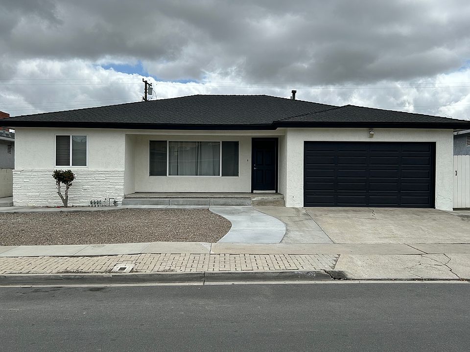 Front of house prior to installation of new exterior lights and new gate.