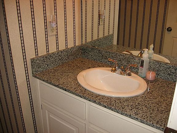 Pretty half bath with granite.