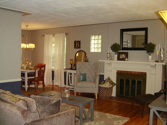 Air of gracious formality in this living room is enhanced by chair rail, coved ceilings, crown molding and gleaming wood floors, and gas log fireplace.  Be as formal or as informal as you wish, but this is a room you will definitely enjoy.