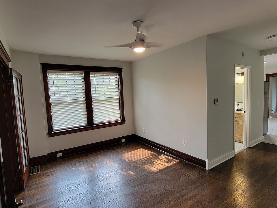 Living Area with view down hall where bathroom is on left and kitchen and then bedroom 2 are straight ahead.