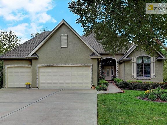 Three car garage with extra garage space and workshop in Lower Level of this home! Notice the nice flat driveway on a quiet culdesac street.