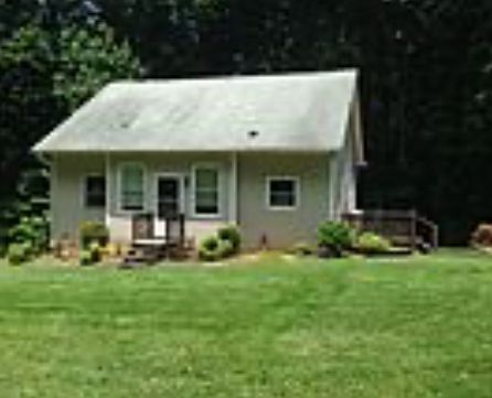 Picture of home in the summer with lawn hand-seeded with Zoysia golf course grass that feels like you're walking on a pillow.
