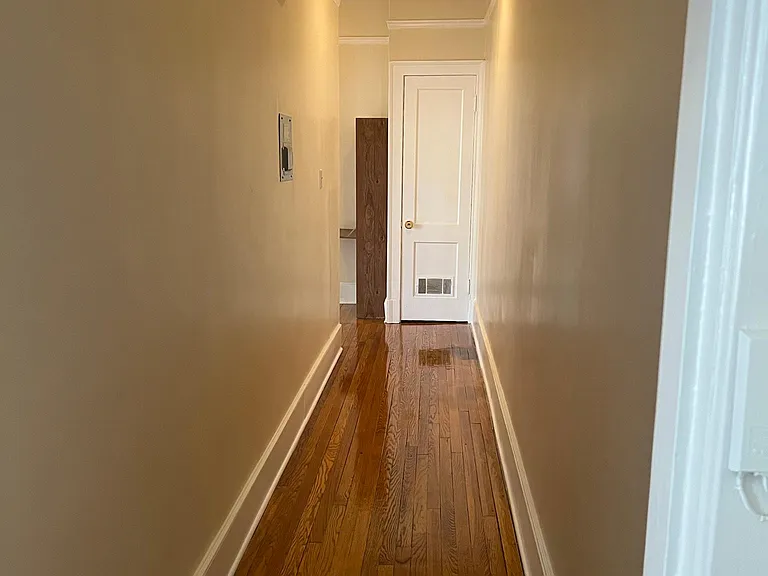 Hallway linen closet leads from den and bath down to Kitchen.
