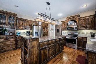 Cozy, beautiful, kitchen with lots of counter and cabinet space. Gas stove, panty with slide out drawers. Walk right onto the deck to sit and listen to the bids in the spring while sipping coffee, watch deer crossing the backyard in fall.