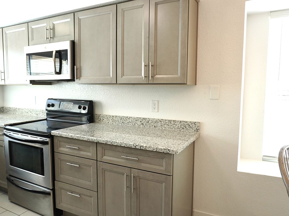 Kitchen with new cabinets, counter tops, sink, dual pane windows.