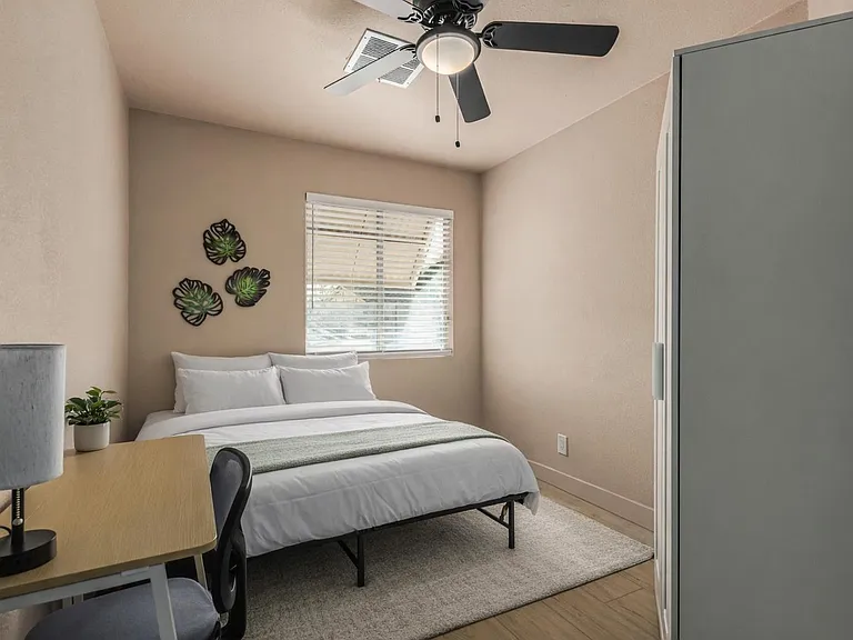 Full size bed, desk, chair, lamp, fan, closet. Bedding and rug are virtually staged.