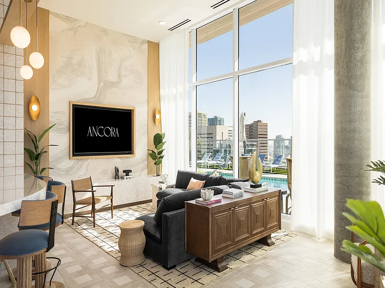 Chic apartment living room featuring modern decor, floor-to-ceiling windows, and a stunning city view with pool access.