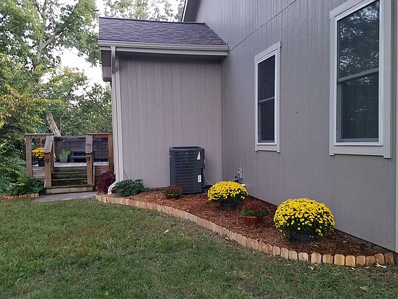 Back-side of Home, Beautifully landscaped, lots of trees. Back deck and hot-tub off master Bedroom, also shows Lg 8x10 Walk in custom Closet. (Bump-Out.
