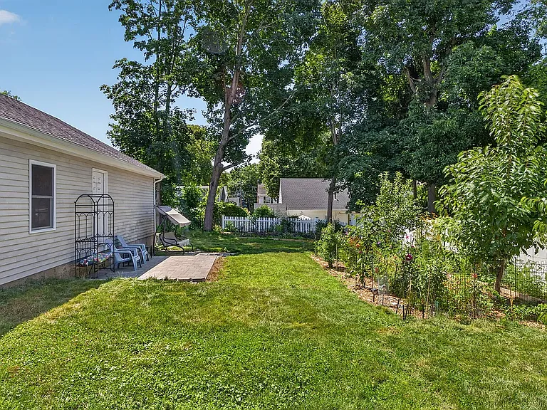 Deep backyard with fruit orchard and flower garden in the summer
