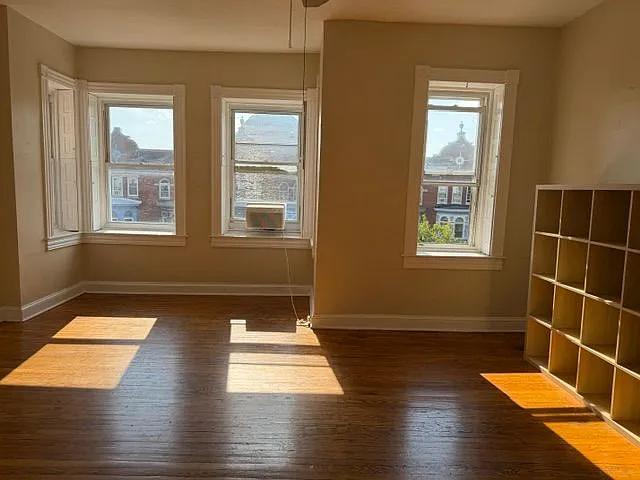 Unfurnished Front Room w/ Western Exposure - Bookcase remains 1/3