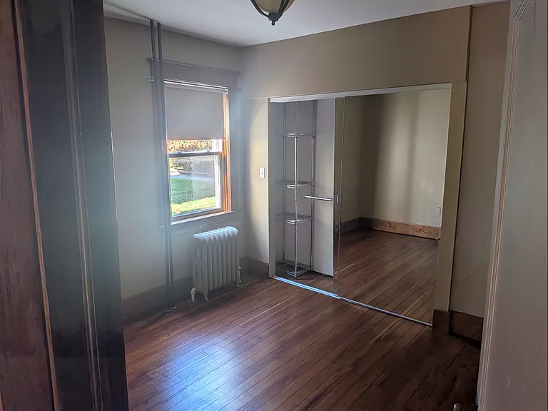 Bedroom with mirrored sliding door closets & stainless shelving