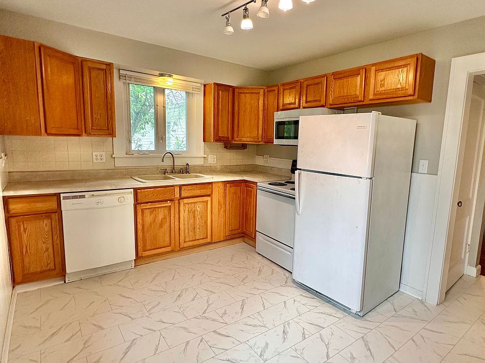 Kitchen with new floors, microwave, & lighting.