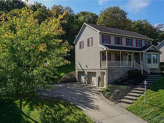 Greet guests on the front porch.  A spacious garage provides ample space for storage and toys.