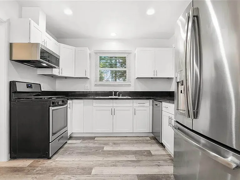 Beautifully updated kitchen with white shaker cabinetry, granite counters, brushed nickel pulls and handels, stainless appliances and more