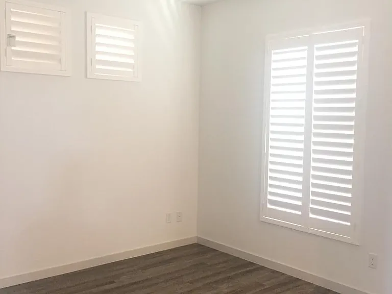 Bedroom with Plantation Shutters for Privacy