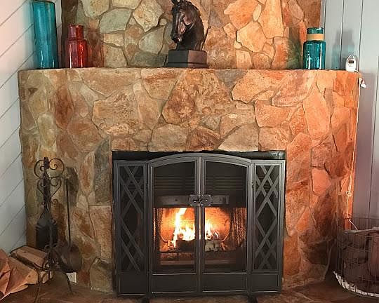 Fireplace. Living room floor is the same stone.