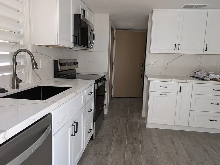 New kitchen cabinets, countertops, sink, faucette, and appliances.