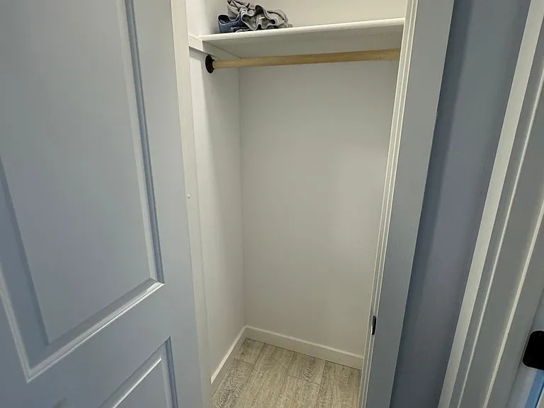 closet for front master suite with two shelves and hanging bar. Lock on the door for privacy.