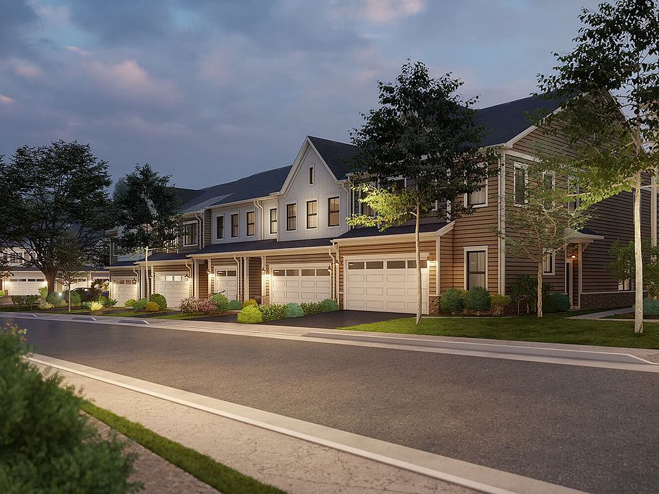 An evening street view of the villas within Cadence at Lansdowne by Brookfield Residential in Loudou