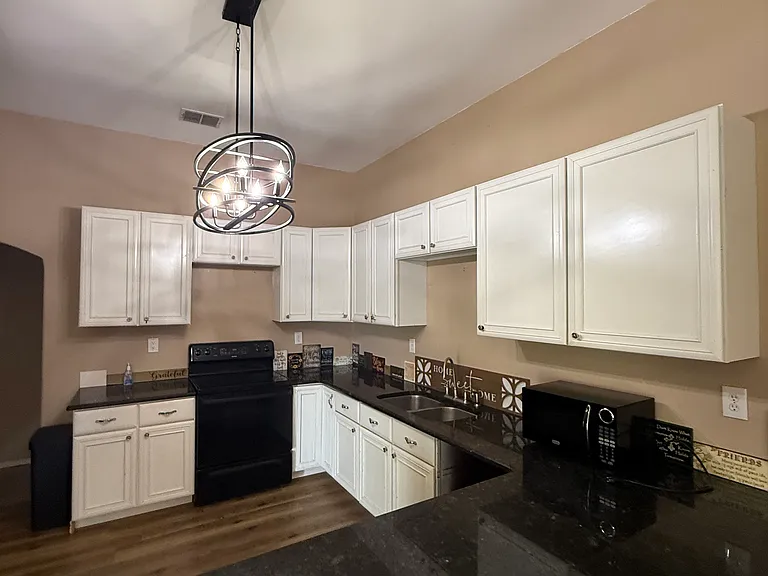 Kitchen with granite counter tops/open concept to the Livingroom