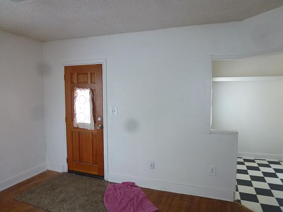 Living room toward front door , kitchen to the right