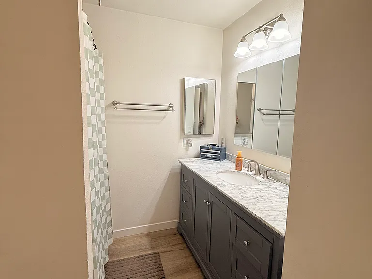 Bathroom has large inset medicine cabinet above sink