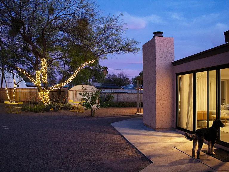 Private fenced backyard with outdoor lighting and indoor_outdoor living.
