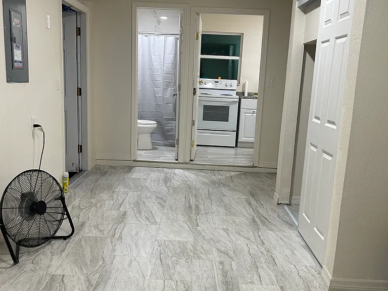 Spacious open living space with easy access to the kitchen and bathroom.