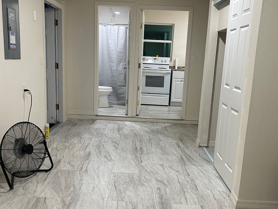 Spacious open living space with easy access to the kitchen and bathroom.