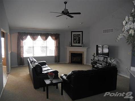 The spacious living room and gas fireplace create a very comfortable environment.
