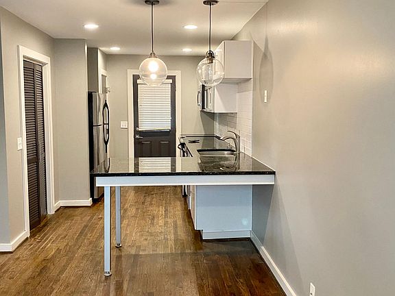 Open floor plan features granite countertops, stainless steel appliances, washer and dryer.
