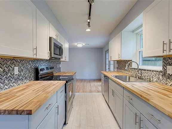 Newly remodeled kitchen with new appliances and butcher block countertops. Refrigerator, washer & dryer included.