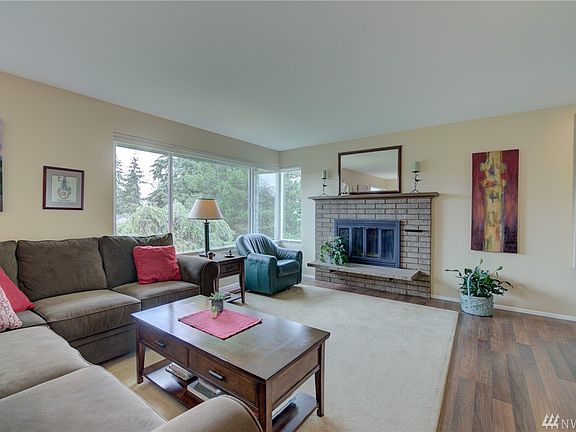 Large and bright living room with wood burning fireplace