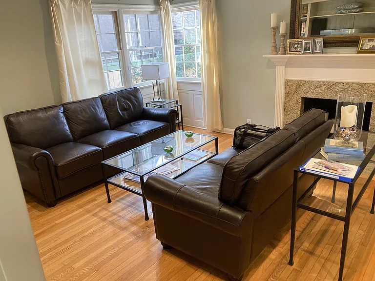 Large living room (this shows about half of it) with clean furniture, TV, stereo and lots of natural light.