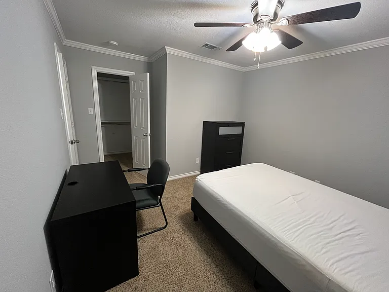Secondary Bedroom #1, furnished with full size bed, tall dresser, desk, chair, & nightstand. Walk in closet. Private space for occupant of secondary bedroom #1.