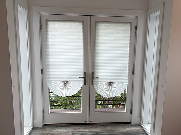 French doors leading to balcony in master bedroom.