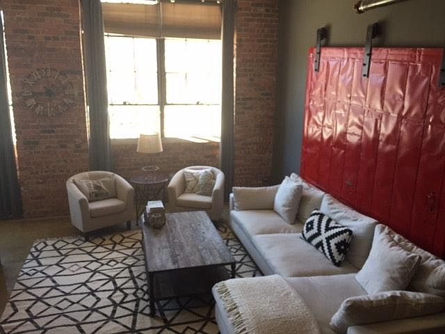 Light filled living room, featuring original fire door from