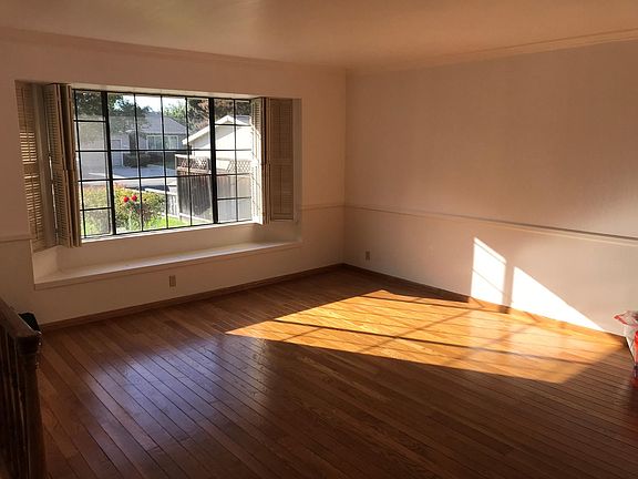 Front Family Room with Built in Cabinets & Wooden Shutters