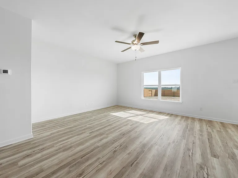 A spacious family room with a ceiling fan.